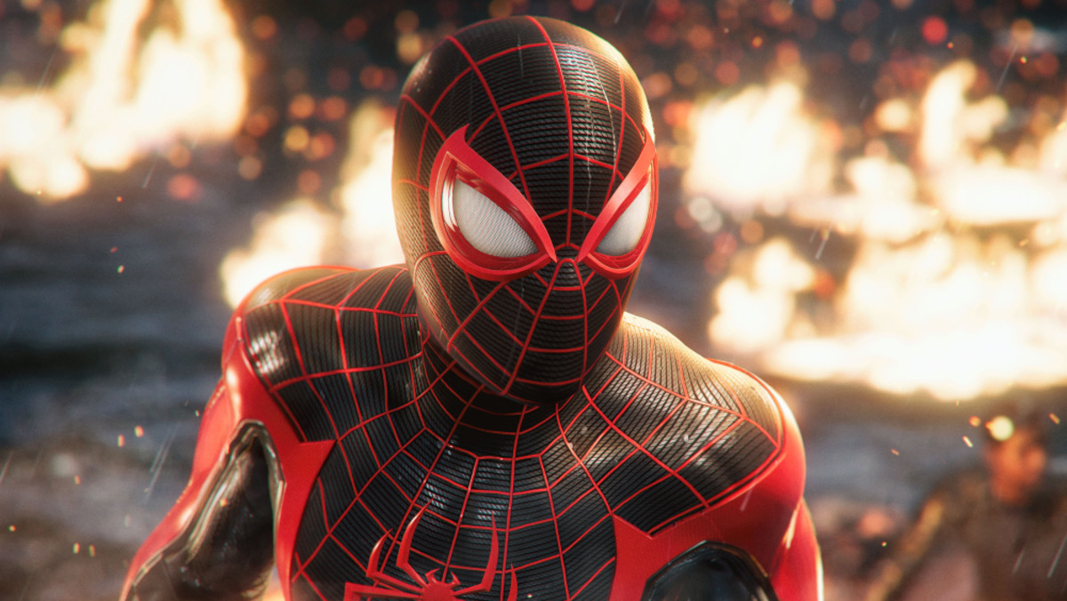 Miles Morales stands in a fiery wreck