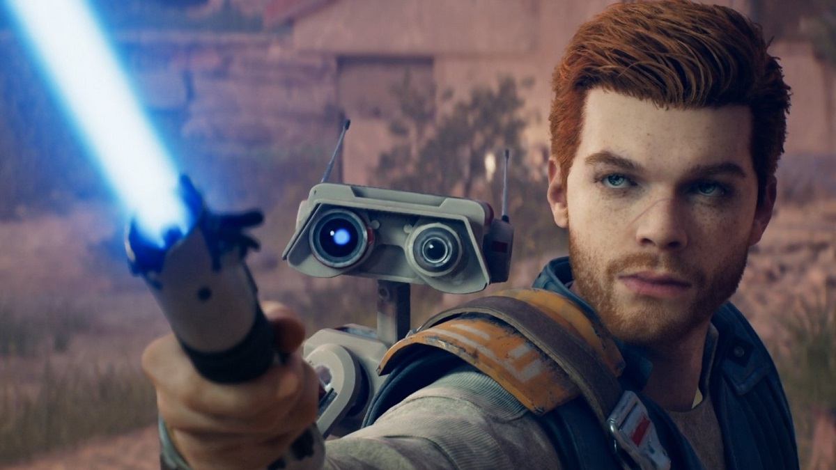 Image of red-haired man with a small robot on his back holding up a blue lightsaber.